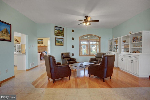 living room with ceiling fan and light tile patterned floors