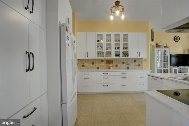 kitchen featuring decorative light fixtures, sink, white cabinets, decorative backsplash, and white appliances