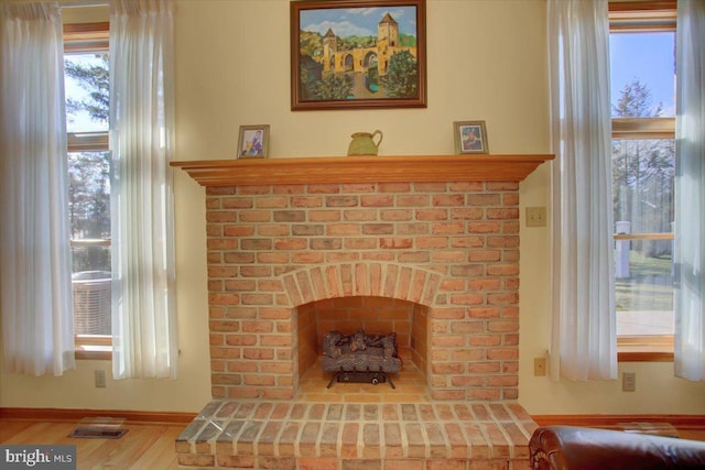 interior details with hardwood / wood-style flooring and a fireplace