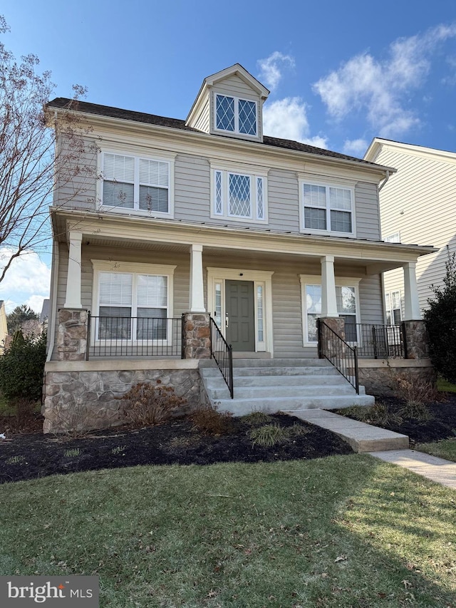 view of front of house with a front lawn and a porch