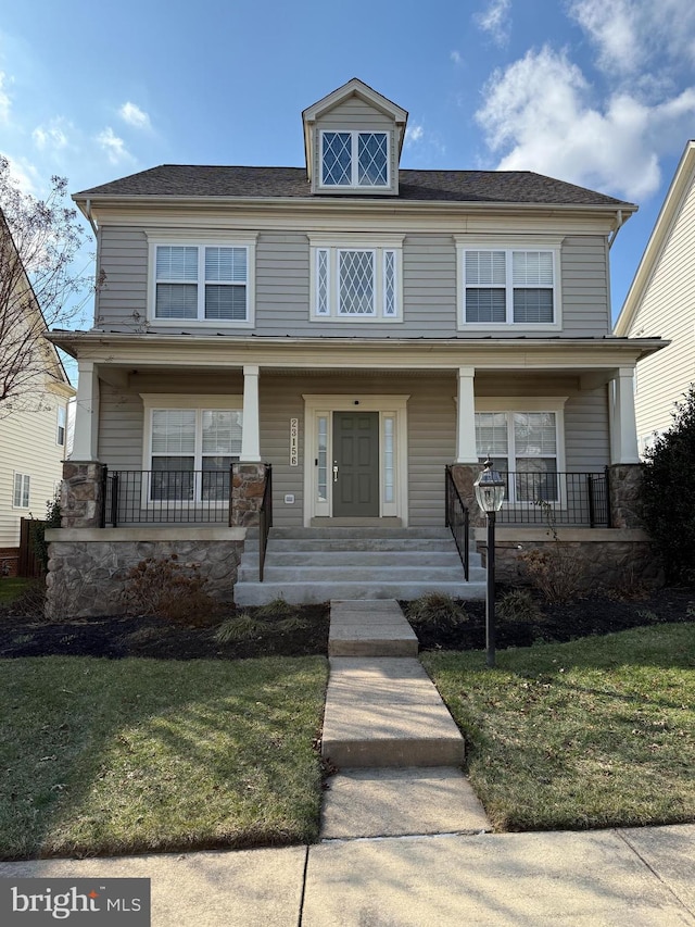 view of front of house featuring covered porch and a front lawn