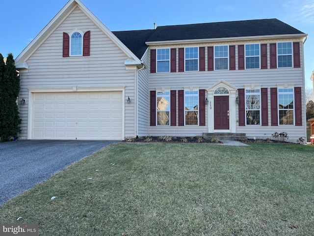 view of front facade with a garage and a front lawn