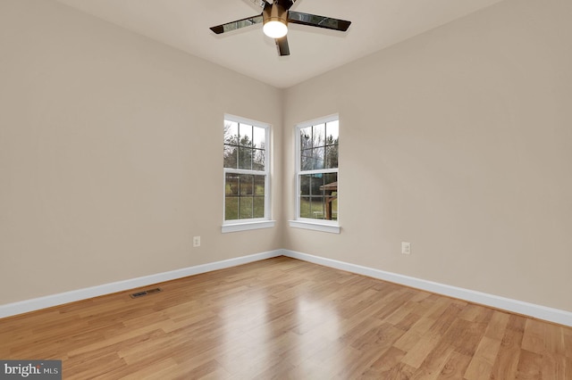 unfurnished room with ceiling fan and light wood-type flooring