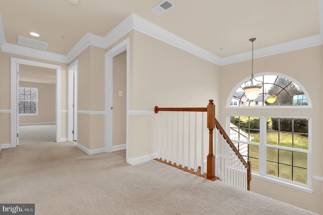 hallway featuring ornamental molding and light colored carpet