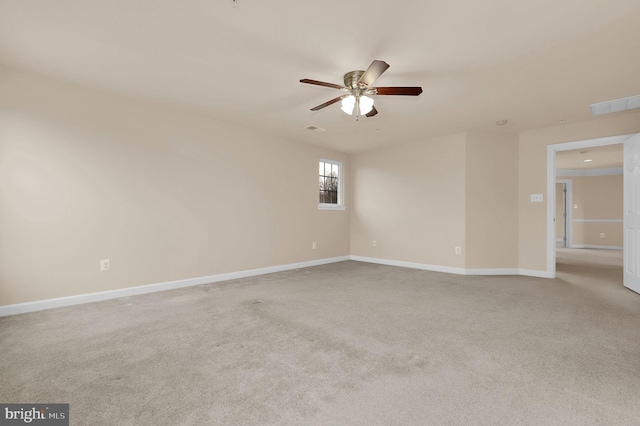 empty room featuring ceiling fan and light carpet