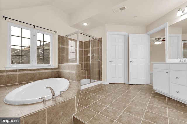 bathroom with vanity, vaulted ceiling, tile patterned floors, and plus walk in shower