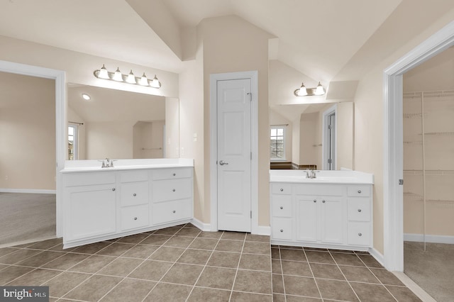 bathroom with vanity, tile patterned flooring, and vaulted ceiling