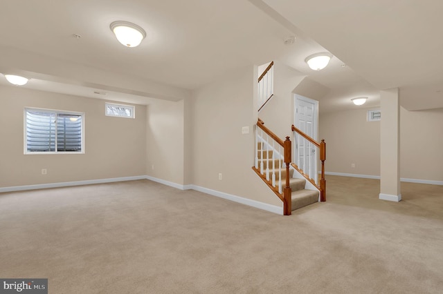 basement featuring light carpet