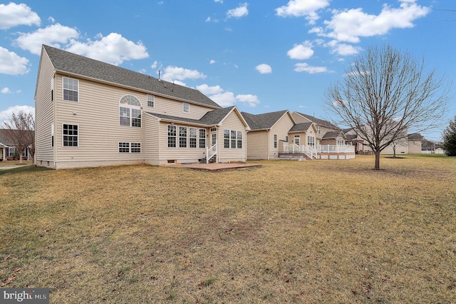 rear view of property with a yard