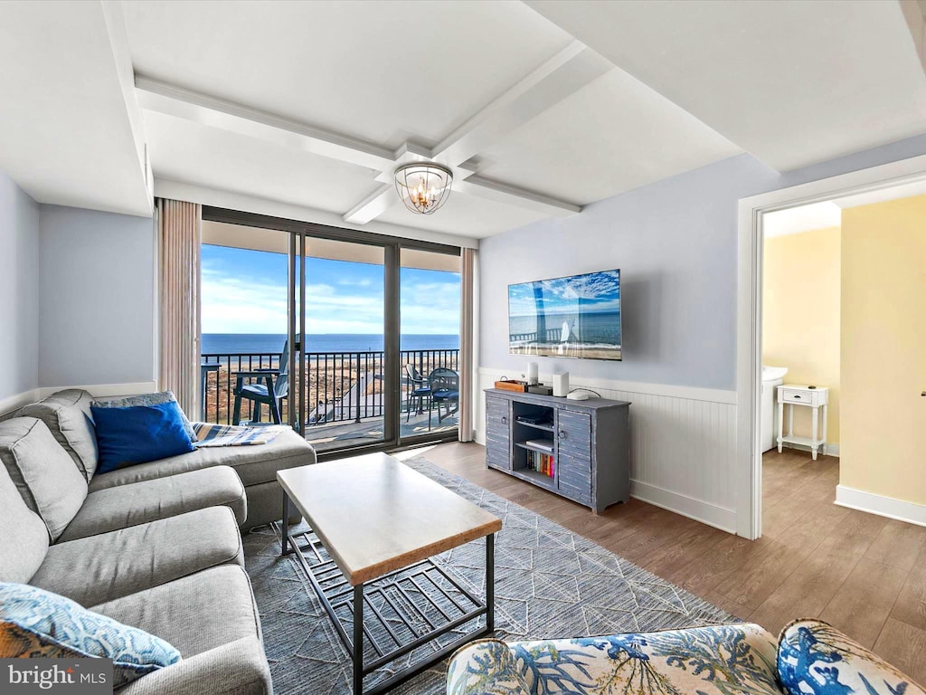 living room featuring coffered ceiling, hardwood / wood-style flooring, and floor to ceiling windows