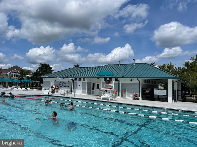 view of swimming pool featuring a patio area