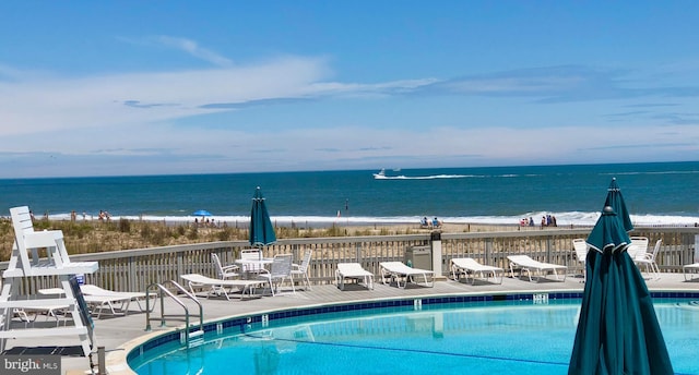 view of swimming pool with a water view