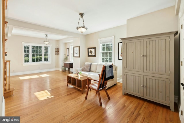 living area with light wood finished floors and baseboards