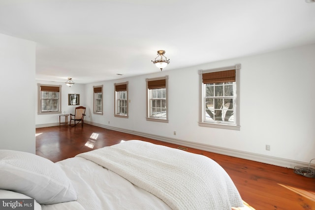 bedroom featuring baseboards and wood finished floors