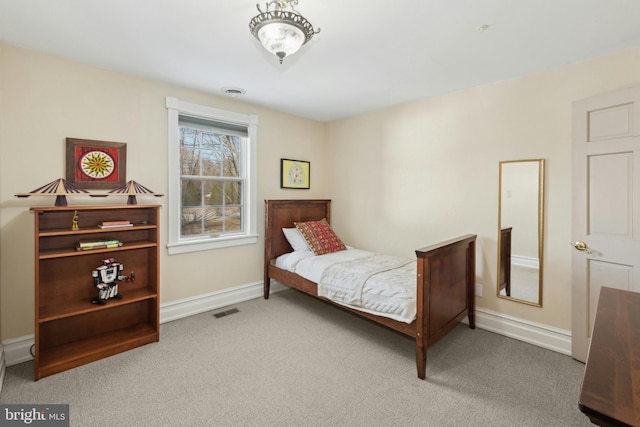 bedroom with carpet, visible vents, and baseboards