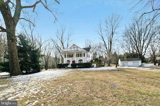 view of front of house with a porch, an outdoor structure, and a garage