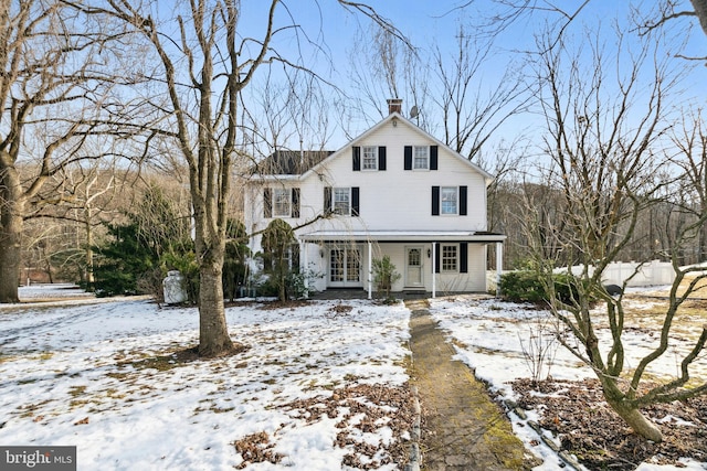 view of front of home featuring a porch and a chimney