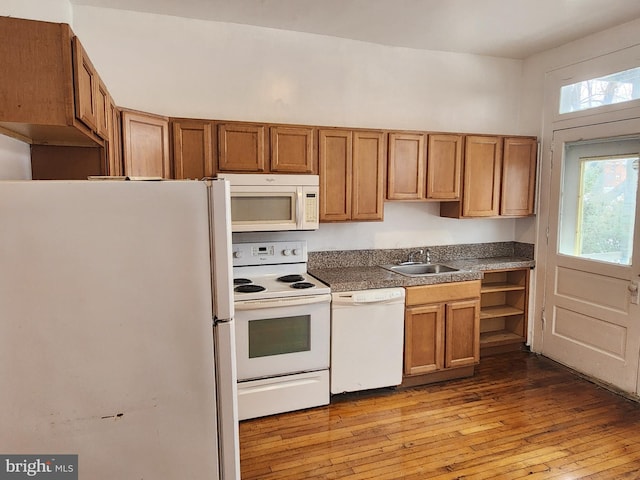 kitchen with white appliances, light hardwood / wood-style floors, and sink