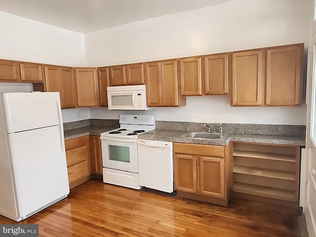 kitchen with white appliances, sink, and light wood-type flooring