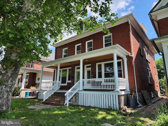 view of front of property featuring a front lawn and a porch