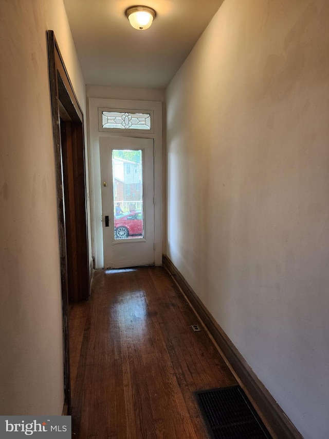 doorway with dark hardwood / wood-style floors