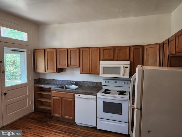 kitchen with dark hardwood / wood-style floors, sink, and white appliances