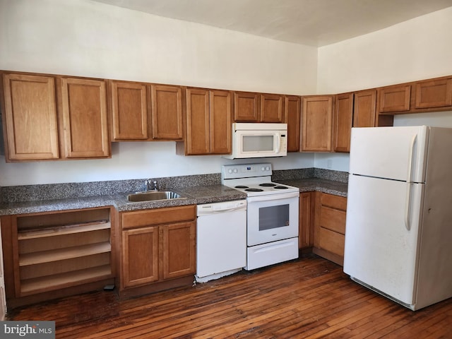 kitchen featuring dark wood-type flooring, white appliances, and sink