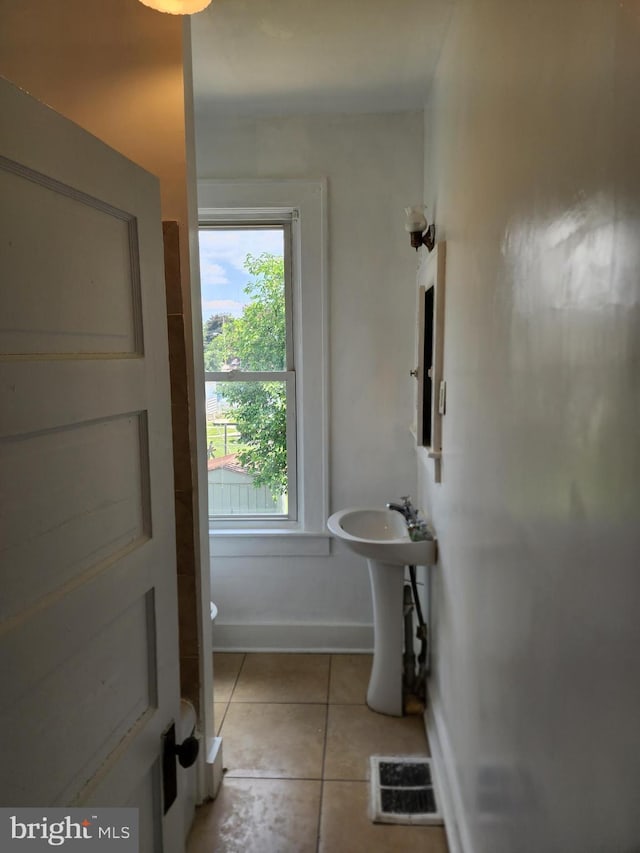 bathroom featuring tile patterned flooring and sink