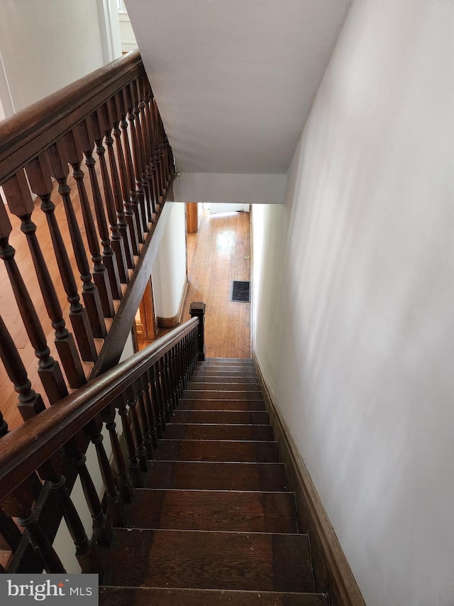 staircase featuring hardwood / wood-style flooring