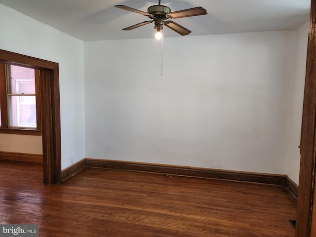 unfurnished room with ceiling fan and dark hardwood / wood-style flooring