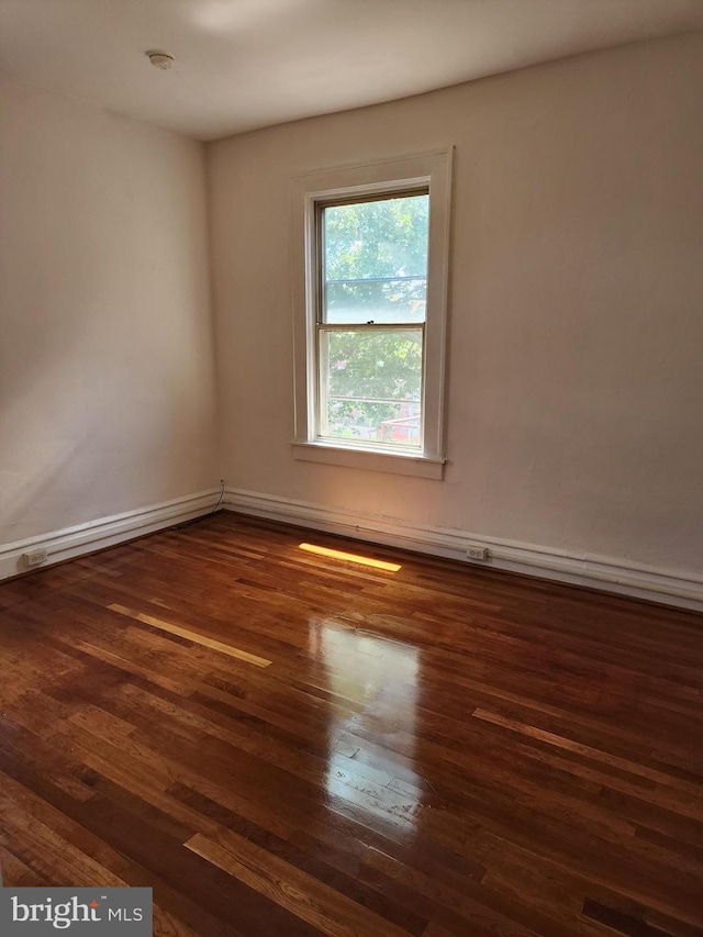 spare room with dark hardwood / wood-style floors