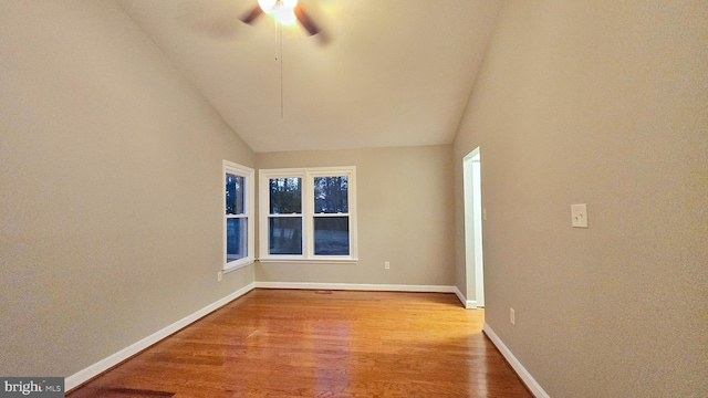 empty room with light wood-type flooring, lofted ceiling, and ceiling fan