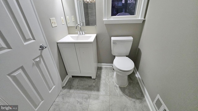 bathroom featuring toilet and vanity