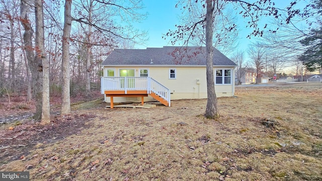 rear view of house with a lawn and a wooden deck