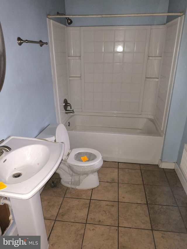 bathroom featuring tile patterned flooring, bathing tub / shower combination, and toilet