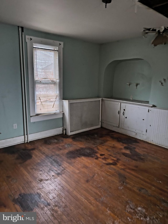 spare room with dark wood-type flooring