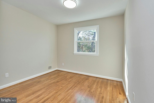 empty room with light hardwood / wood-style flooring