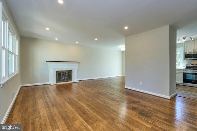 unfurnished living room featuring dark wood-type flooring