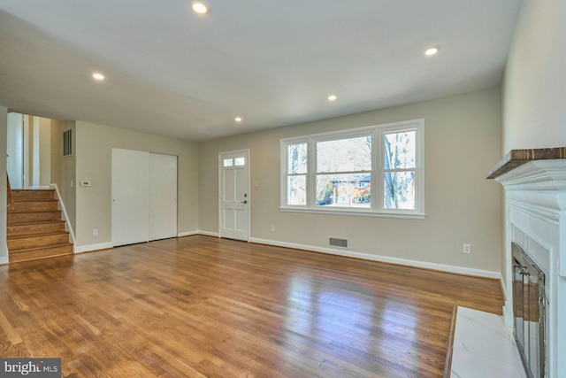 unfurnished living room featuring wood-type flooring