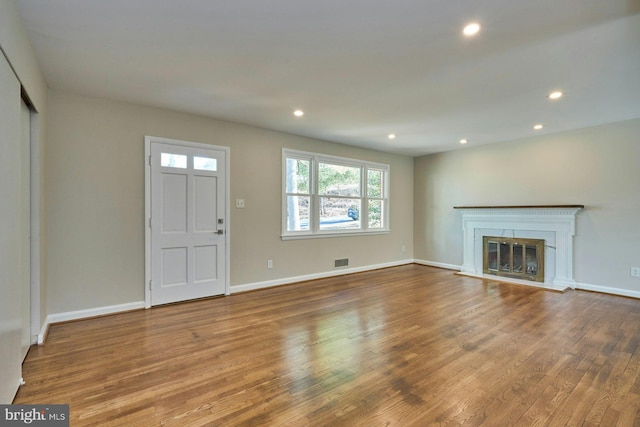 unfurnished living room featuring wood-type flooring