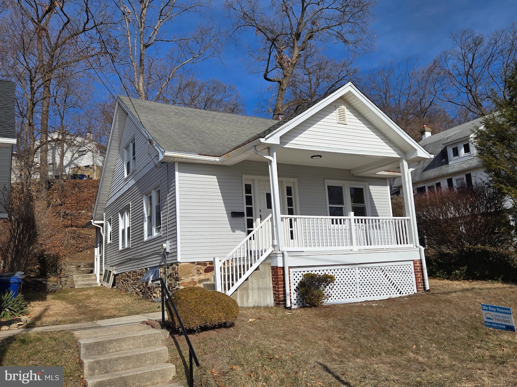 bungalow-style house featuring a porch and a front yard