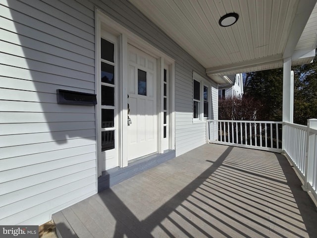 wooden terrace featuring covered porch