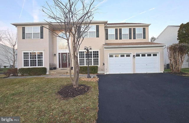 view of front of property featuring central AC unit, a garage, and a front yard