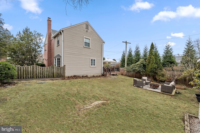 view of property exterior with a yard, an outdoor living space with a fire pit, and a patio