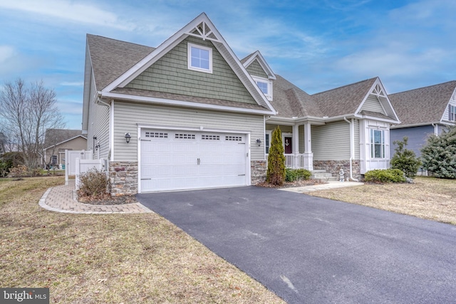 craftsman-style home featuring a garage, a front lawn, and a porch