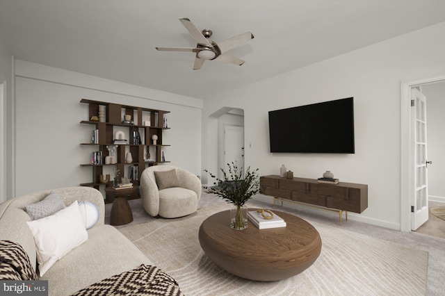 carpeted living room featuring ceiling fan