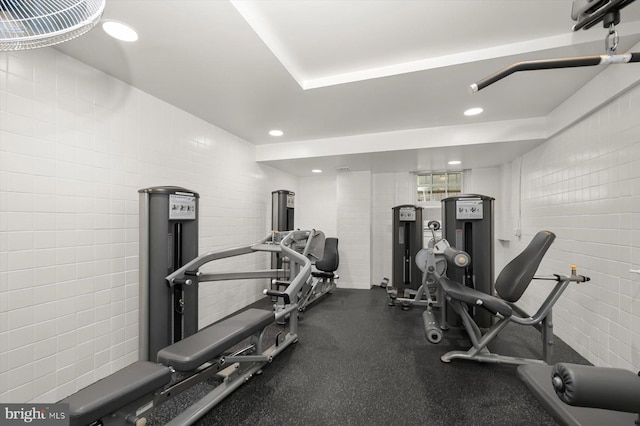 workout room with tile walls