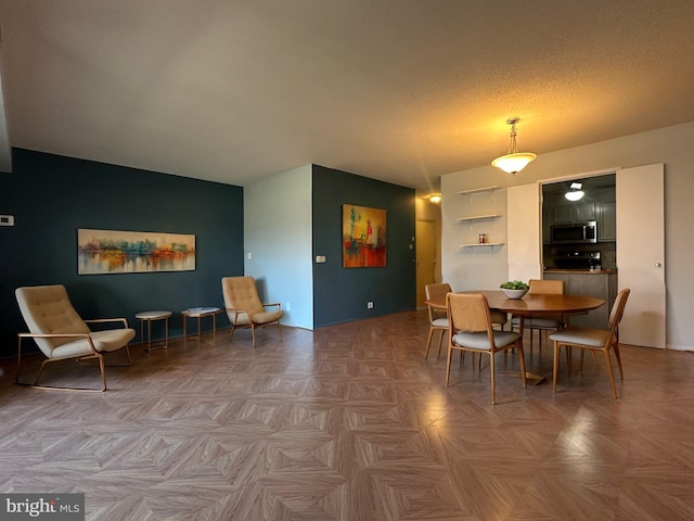 dining area with a textured ceiling and lofted ceiling