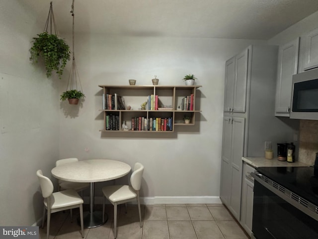 dining area with baseboards and light tile patterned floors