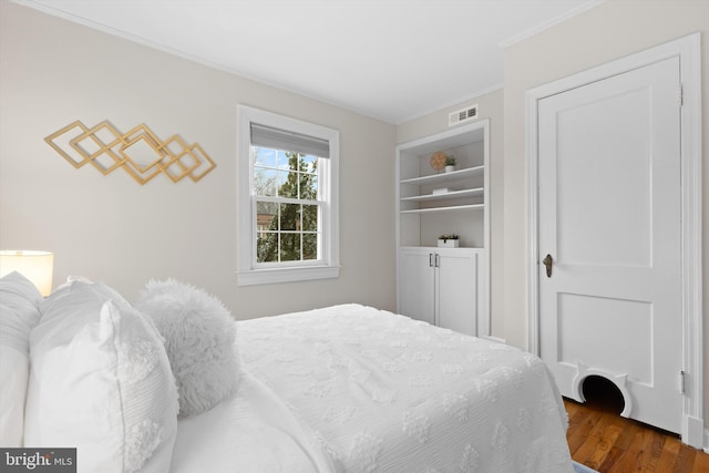 bedroom featuring hardwood / wood-style flooring and ornamental molding